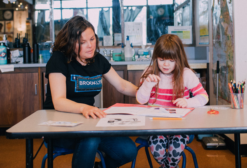 Photo: Student and teacher working together in an EEU classroom setting.